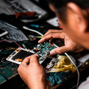 worker fixing smartphone electronics